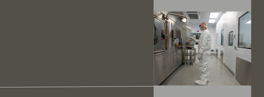 Pharmaceutical worker in a sterile lab environment, emphasizing precision and quality control in pharmaceutical manufacturing.